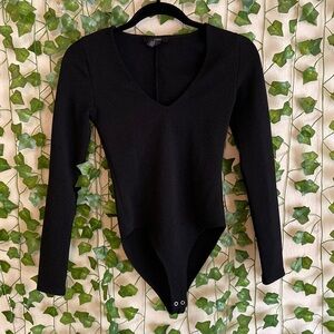 Bodysuit. Almost like ribbed but tire like pattern. Never worn.